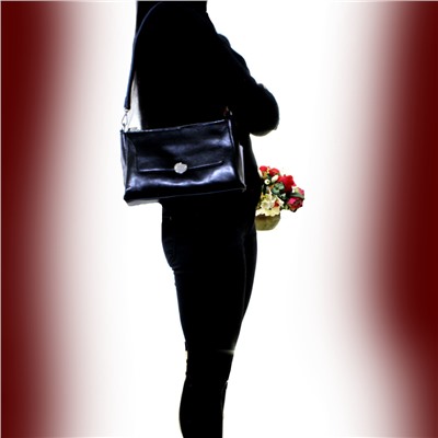 Стильная женская сумочка Dolse_Los из натуральной кожи черного цвета.